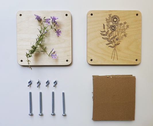 The flower pressing kit laid out to see all the parts. The flower press includes 2 wooden press pieces and hardware.