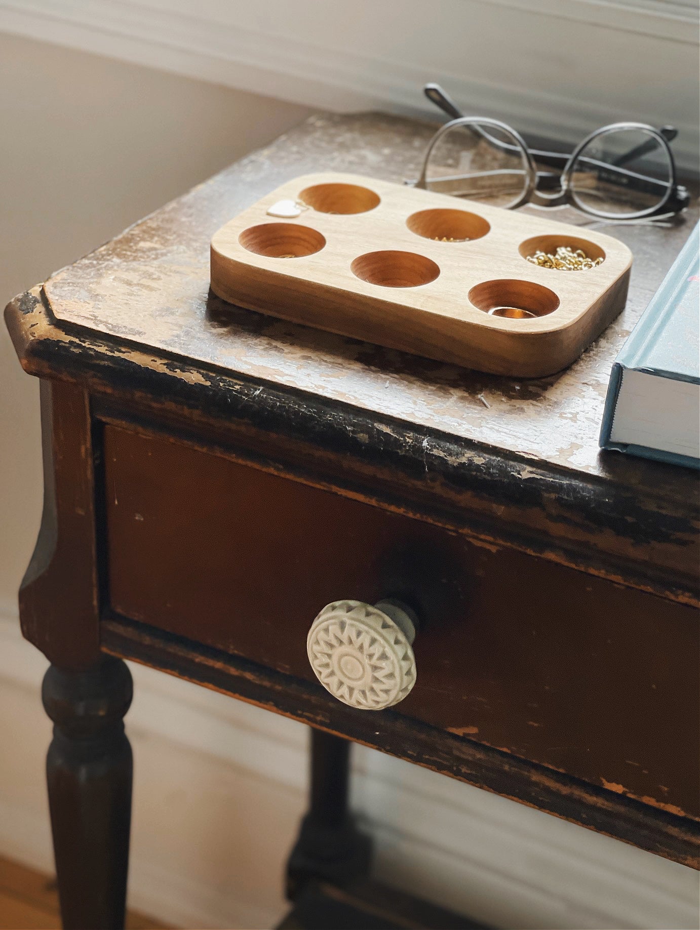 the 6 slot tray styled on an antique table with small jewellery in the slots.